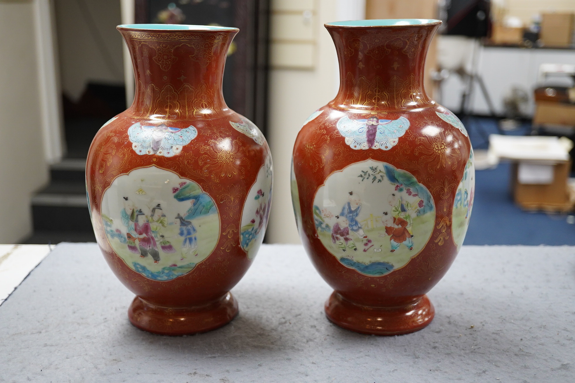 A pair of Chinese coral ground ‘boys’ vases, Jiaqing period (1796-1820)